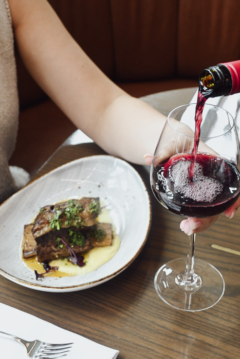 Red wine poured at Auckland airport restaurant dining experience